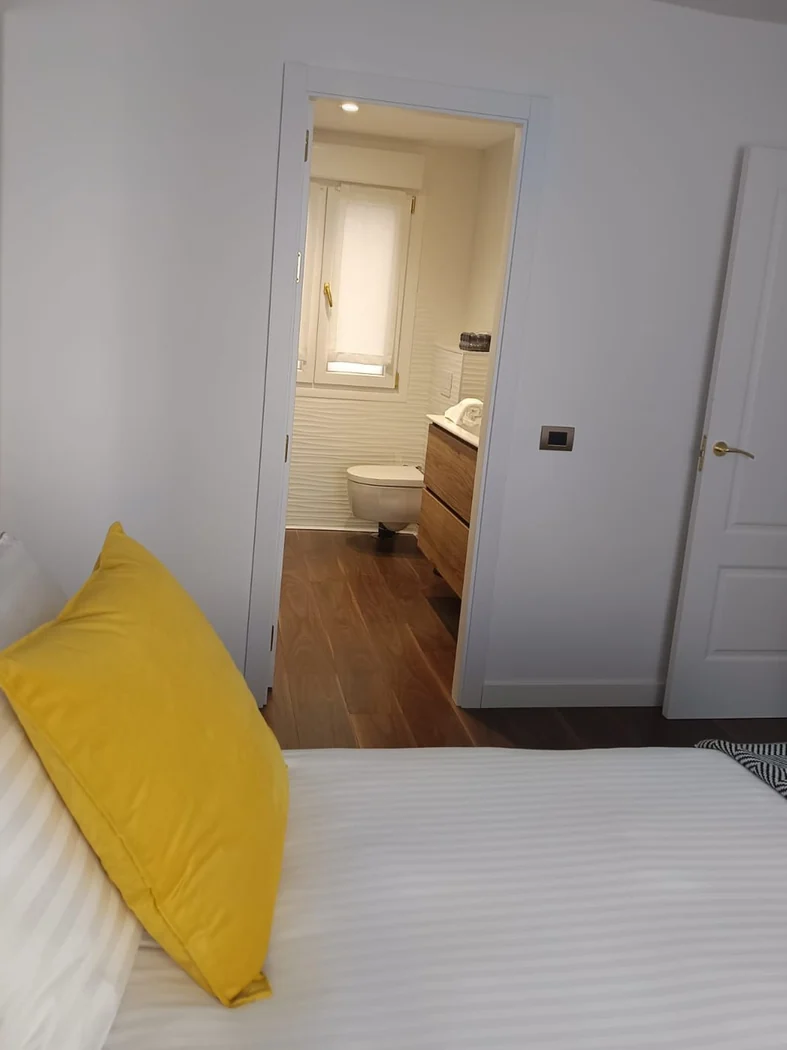 Dormitorio de la suite con vista al baño en suite MM Suites